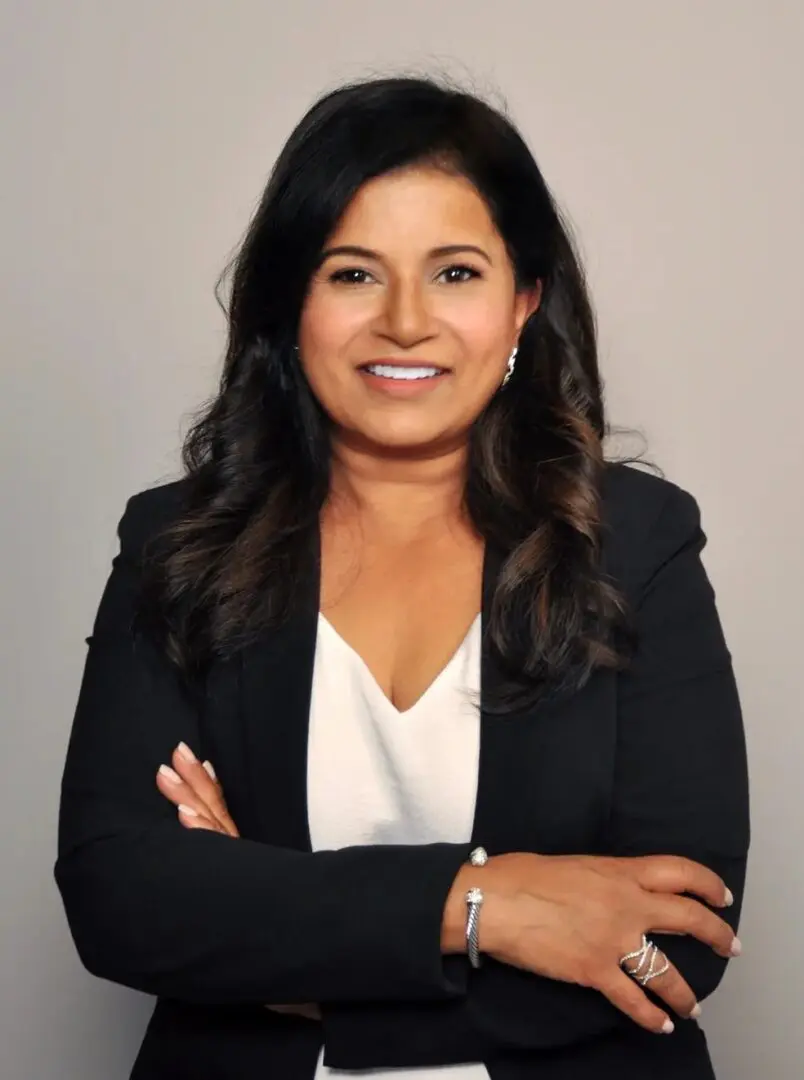 A woman in black jacket posing for a picture.